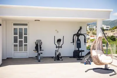 a fitness room with treadmills and exercise equipment at Guest House Pasha in Ulcinj