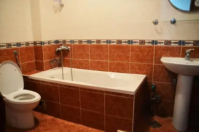 a bathroom with a tub and a toilet and a sink at Apartments Secret Garden in Sveti Stefan