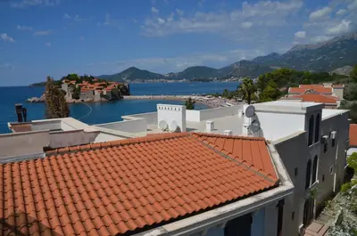 a view of the water and roofs of buildings at Apartments Secret Garden in Sveti Stefan