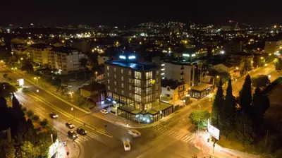 a view of a city at night with lights at Hotel Union in Podgorica