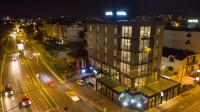a city at night with a building and street lights at Hotel Union in Podgorica