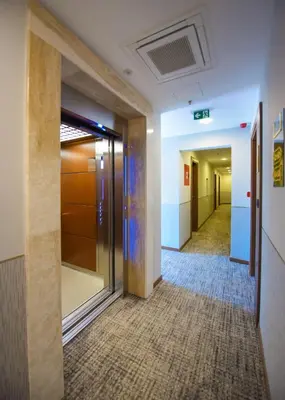 a hallway of an office building with a door and a hallwayngthngthngthngth at Hotel Union in Podgorica