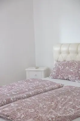 a bedroom with two beds and a night stand at Casa Selimi in Ulcinj