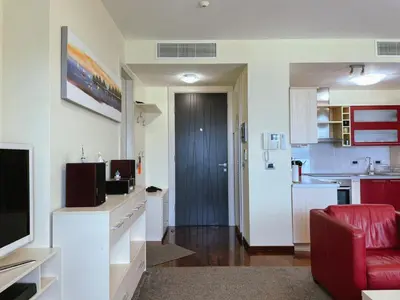 a room with a kitchen and a living room at Oziris apartment in Budva