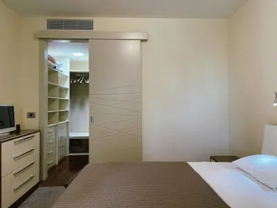 a bedroom with a closet with a bed and a television at Oziris apartment in Budva