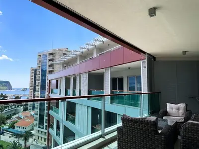a balcony with chairs and a view of a building at Oziris apartment in Budva