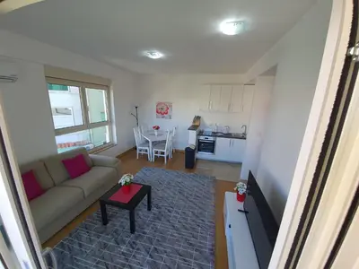 a living room with a couch and a table at AS Apartments Rafailovici in Rafailovici