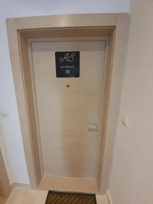 a door in a room with a sign on it at AS Apartments Rafailovici in Rafailovici