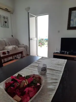 a bowl of food on a table in a living room at Šušanj Ilino APARTMAN in Bar