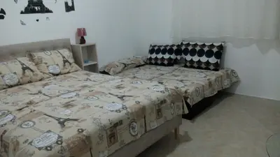 a bedroom with a bed and a couch in it at Šušanj Ilino APARTMAN in Bar