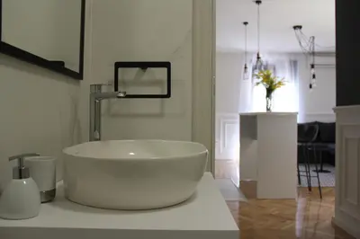 a bathroom with a large white tub on a counter at Apartments Marković in Kotor