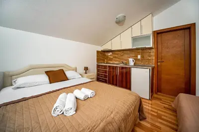 a bedroom with a bed with towels on it at Apartments Marković in Kotor