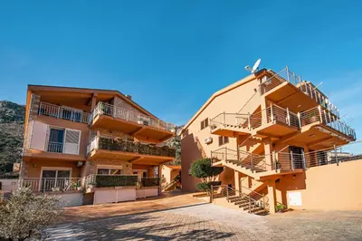 a large apartment building with balconies and stairs at Apartments Marković in Kotor