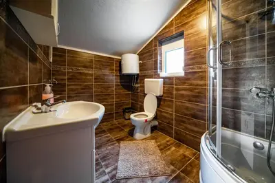 a bathroom with a sink and a toilet and a shower at Apartments Marković in Kotor