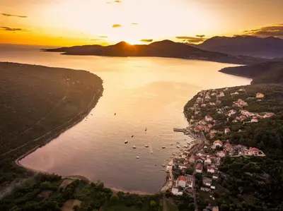 an aerial view of a body of water at sunset at Apartments Vila Lazarevic in Tivat