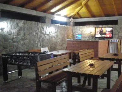 a restaurant with benches and a grill in a room at Apartments Vila Lazarevic in Tivat