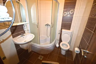 a small bathroom with a sink and a toilet at Apartmani Kovačević in Kotor