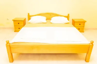 a bedroom with a wooden bed with two night stands at Casa Agata in Ulcinj