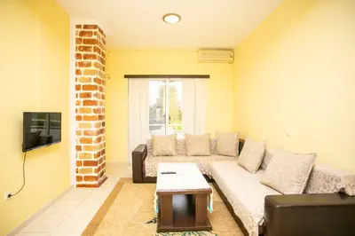 a living room with a couch and a tv at Casa Agata in Ulcinj