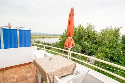 a patio with an umbrella and a table and chairs at Casa Agata in Ulcinj