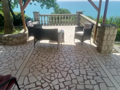 a patio with two chairs and a table at Blue Horizon in Dobra Voda