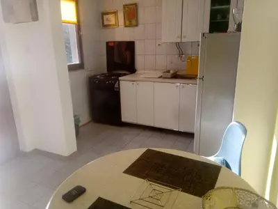 a kitchen with a table and a kitchen with a refrigerator at Blue Horizon in Dobra Voda