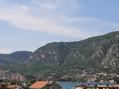 a view of a town and a body of water and mountains at Apartments Dakovic in Kotor