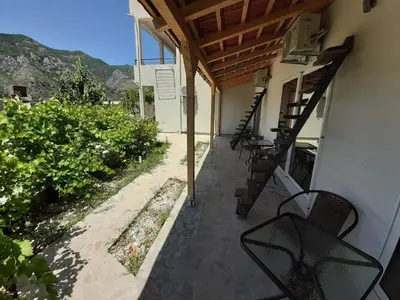 a patio with chairs and a stairway to a building at Apartments Dakovic in Kotor