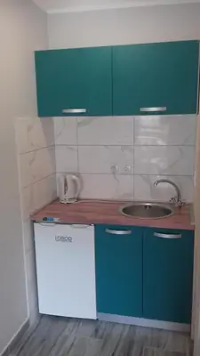 a kitchen with green cabinets and a sink at Apartments Dakovic in Kotor