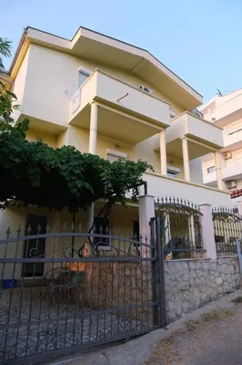 a building with a fence in front of it at Apartments Jasmina in Utjeha