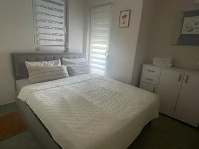 a bedroom with a bed with white sheets and pillows at Apartments Jasmina in Utjeha