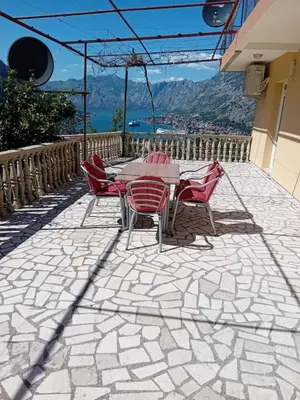 a table and chairs on a patio with a view at Apartments Vidikovac Inn in Kotor