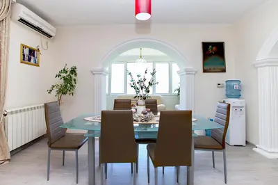 a dining room with a blue table and chairs at Apartments Vidikovac Inn in Kotor