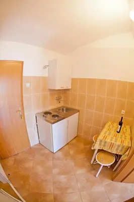 a small kitchen with a sink and a table at Apartments Stanka in Becici