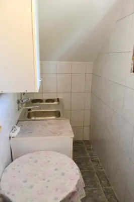 a small kitchen with a sink and a counter at Apartments Stanka in Becici