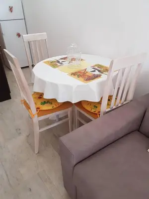 a white table with two chairs and a couch at Studio in Tivat