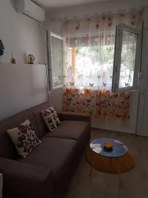 a living room with a couch and a table at Studio in Tivat