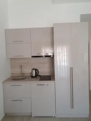 a kitchen with white cabinets and a sink at Apartments Boreta in Budva