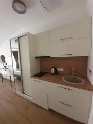 a kitchen with white cabinets and a sink at Apartments Boreta in Budva