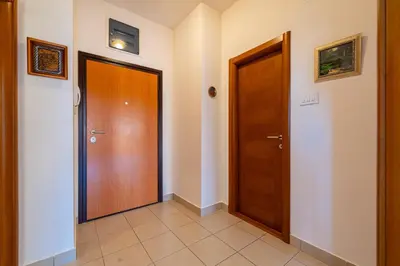 a hallway with two doors and a tiled floor at Family One bedroom apartment with Panoramic city view in Budva
