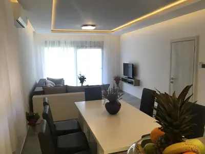 a living room with a table and a couch at Apartmani Novaković in Kotor