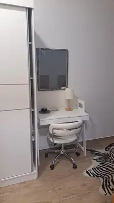 a white desk with a computer and a chair at Auto kamp Titograd in Podgorica
