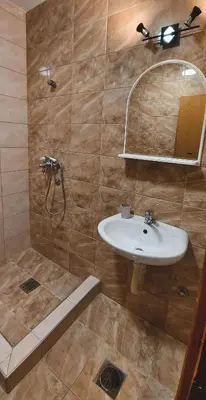 a bathroom with a sink and a shower at Auto kamp Titograd in Podgorica