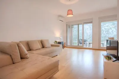 a living room with a couch and a television at Aria Apartments in Kotor