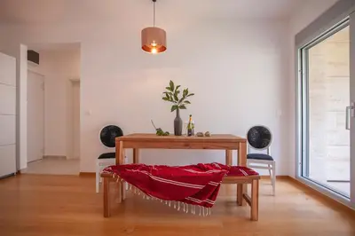 a table with a red blanket on it in a room at Aria Apartments in Kotor
