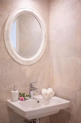 a bathroom with a sink and a mirror at Aria Apartments in Kotor