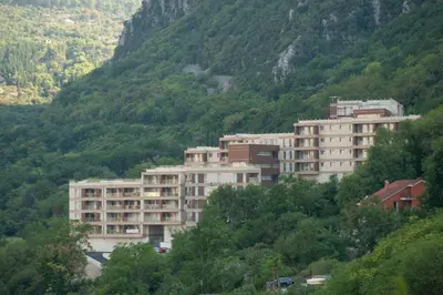 a group of buildings on the side of a mountain at Aria Apartments in Kotor