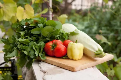 a bunch of vegetables sitting on a cutting board at B&B Apart Hotel Paštrovski Konak in Sveti Stefan