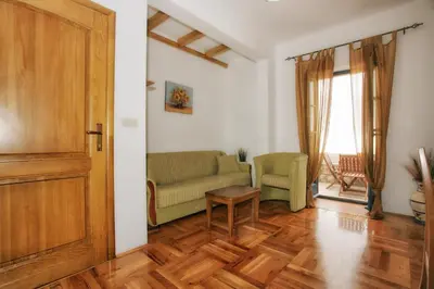 a living room with a couch and a table at B&B Apart Hotel Paštrovski Konak in Sveti Stefan
