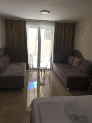 a living room with two couches and a table at Soheds in Budva